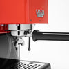 Close-up of a Gaggia Classic coffee machine with a bright red body, polished chrome portafilter and steam wand, and a black handle on a white background.

